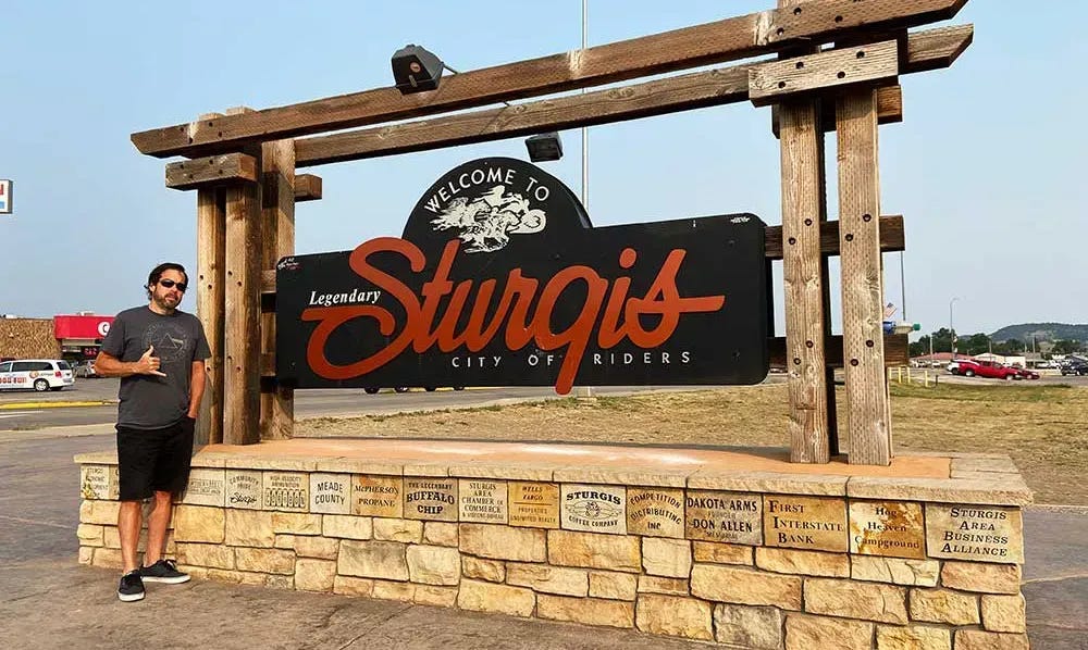 James standing in front of the Sturgis sign.